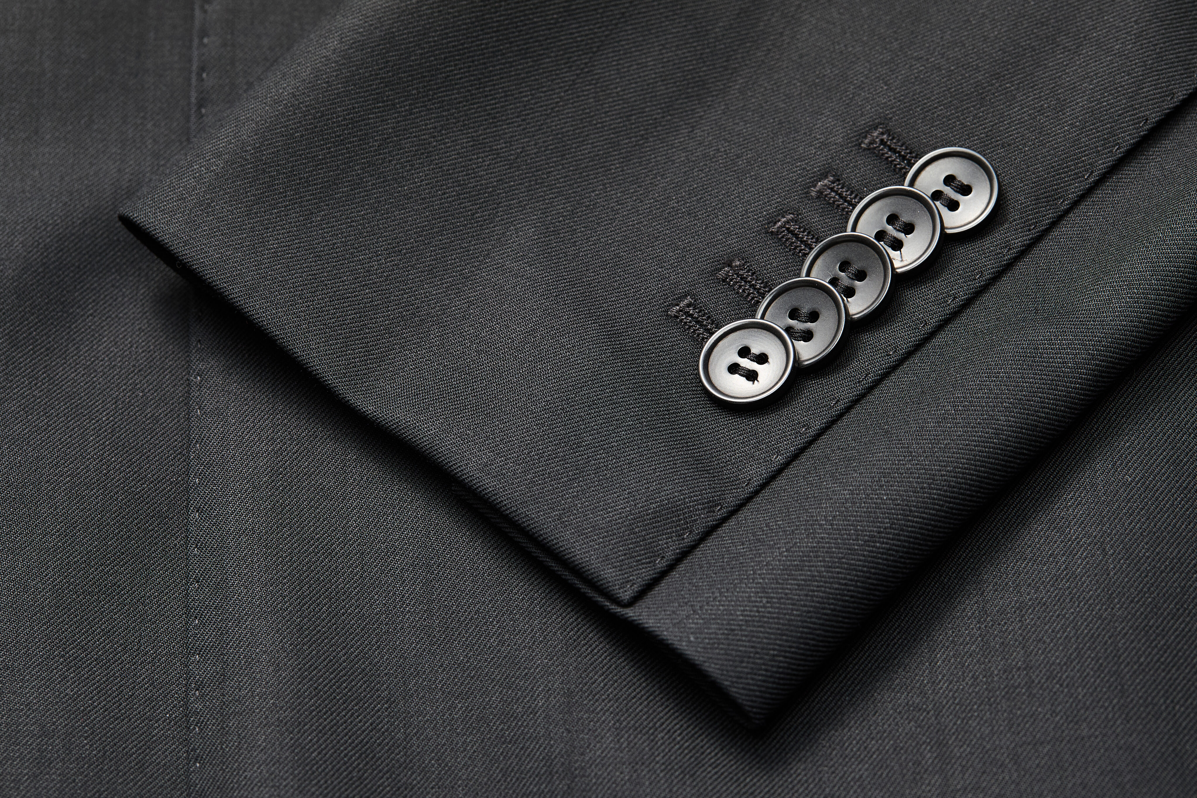 Five-button sleeve cuff detail on black 4×2 jacket
