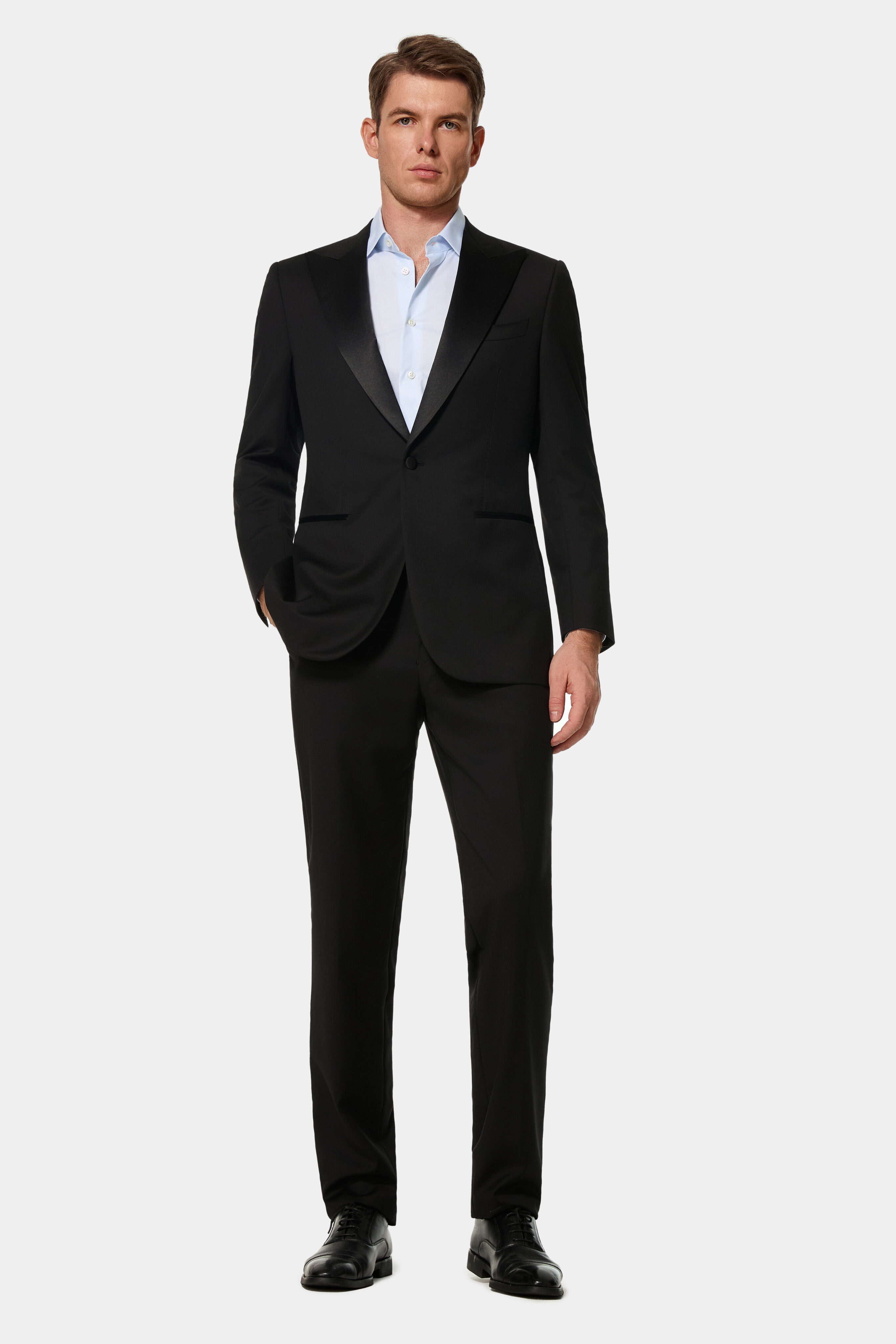 Black one-button tuxedo jacket with silk peak lapel — front view.